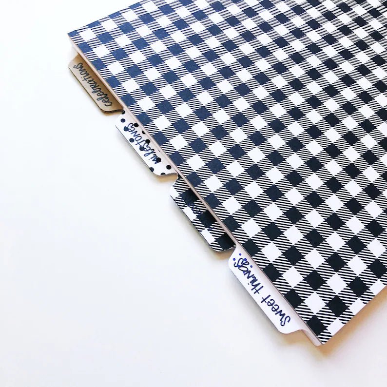 back cover of the baby book is a large scale black and white gingham print. Also shows another angle of the tabbed sections within the baby book.
