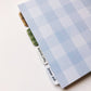 back cover of pregnancy journal is a large scale light blue gingham print. Also shows another angle of the tabbed sections with the pregnancy journal
